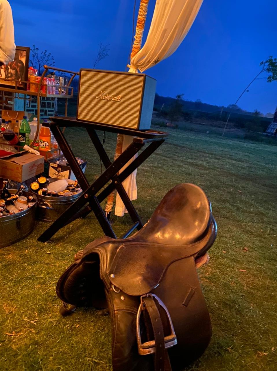 A saddle and an evening set-up beneath the canopy